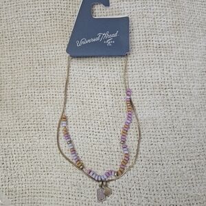 Double strand necklace with beads and charms. Approximately "18